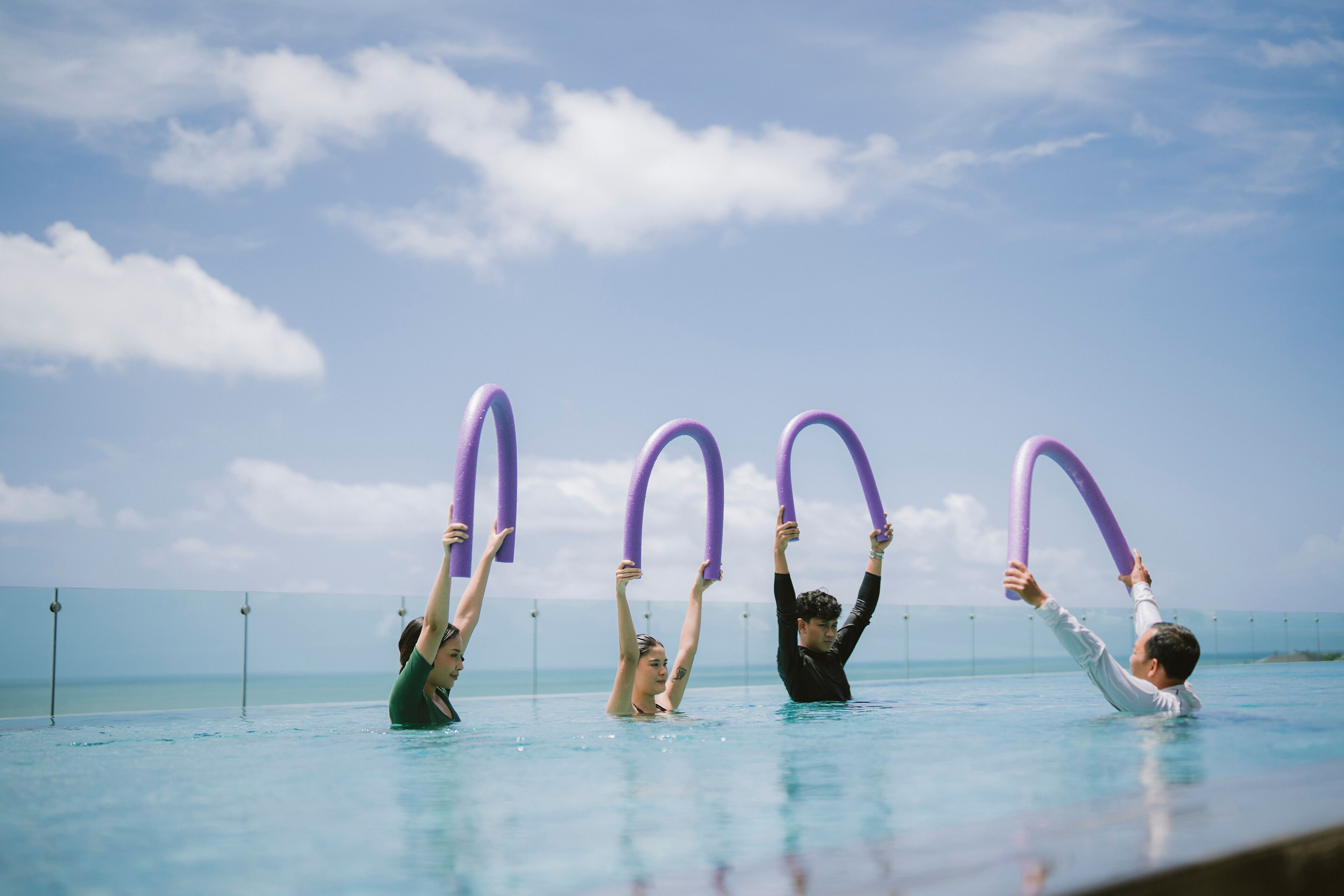 A swimming pool with clear blue water and a view of the ocean.