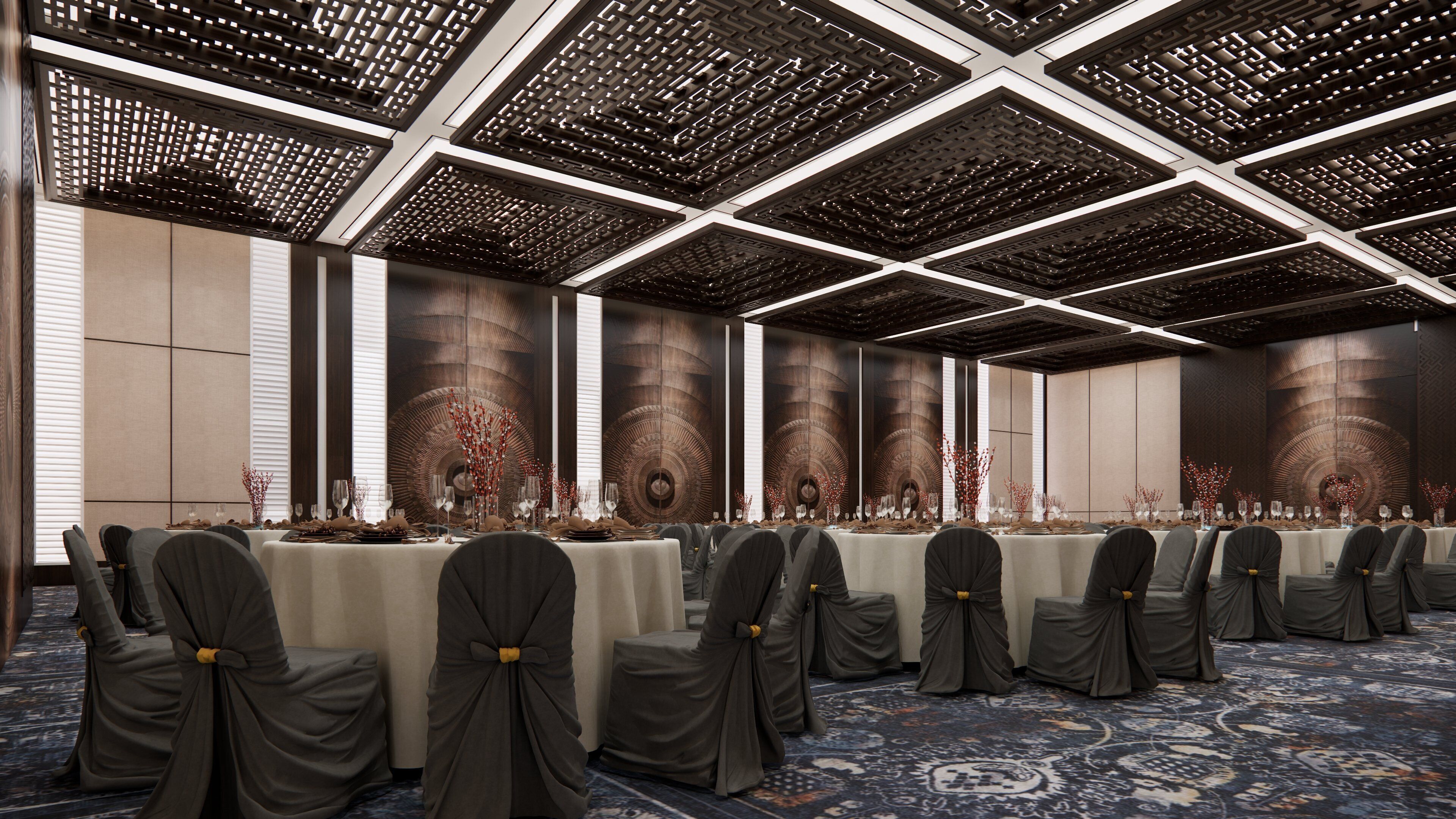 A conference room with a long table, chairs with bows, and a patterned carpet.