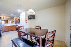 A modern kitchen with wooden cabinets, a dining table, and a built-in oven. - Fenced Yard, Workspace, Garage: Ft Worth Home Base (Fort Worth)