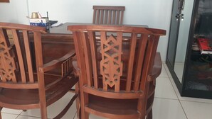 A dining area with a wooden table and chairs.