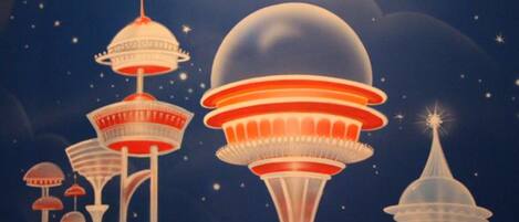 A stylized illustration of futuristic, multi-tiered structures with a night sky background.