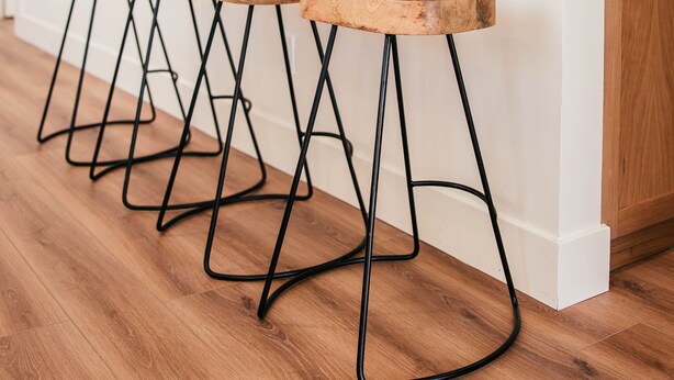 A kitchen with wooden stools, a white countertop, and a tiled backsplash. - Luxury Village Home Close to Beaches and Wineries! (Arroyo Grande)