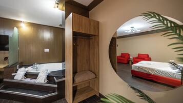 A modern bathroom with a bathtub, a wooden vanity, and a mirror.