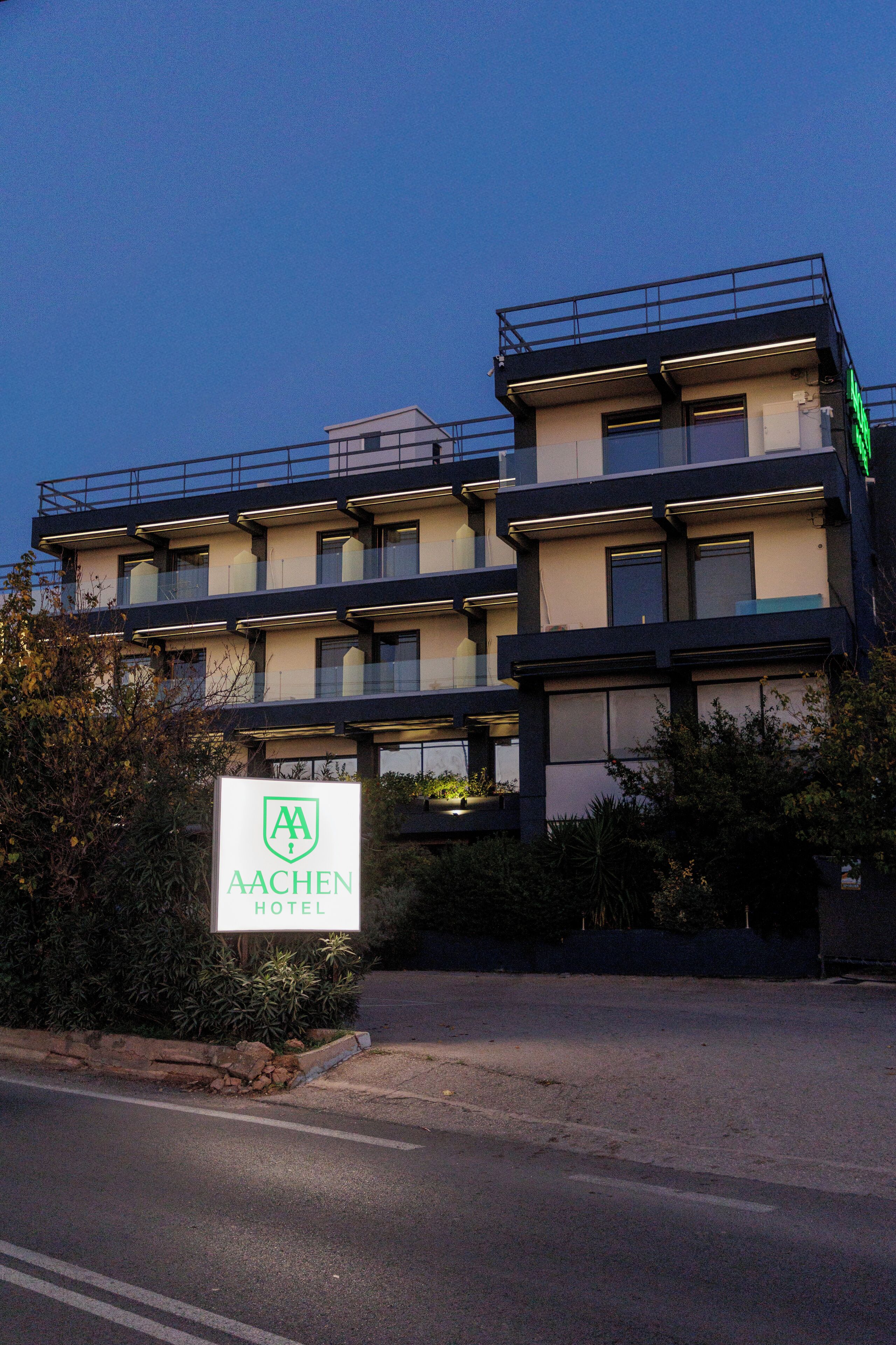 A multi-story hotel with a sign indicating it is the Aachen Hotel.