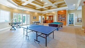 A spacious indoor recreational area with a ping pong table, a pool table, and a billiards table. - Theme Park Paradise! (Kissimmee)