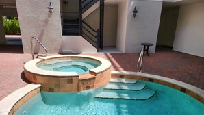 A swimming pool with a hot tub, a staircase, and a small table. - Memories Await, Garber Getaways! Waterfront retreat, 100 steps to private beach! (Naples)