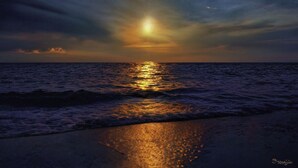 A beach scene with a sunset over the ocean. - Memories Await, Garber Getaways! Waterfront retreat, 100 steps to private beach! (Naples)