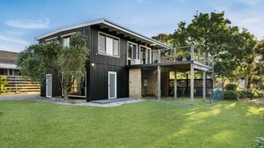 A modern two-story house with a flat roof, large windows, and a covered outdoor area. - Anderson Getaway in Cowes (Cowes)
