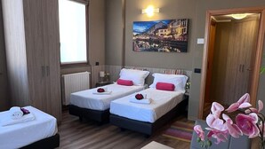A hotel room with two beds, a radiator, a painting of a cityscape, and a window. - Bnbook TommasoGrossi Studio (Rho)