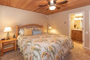 Relax in this serene bedroom with a large bed, bedside lamps, and a convenient nightstand.