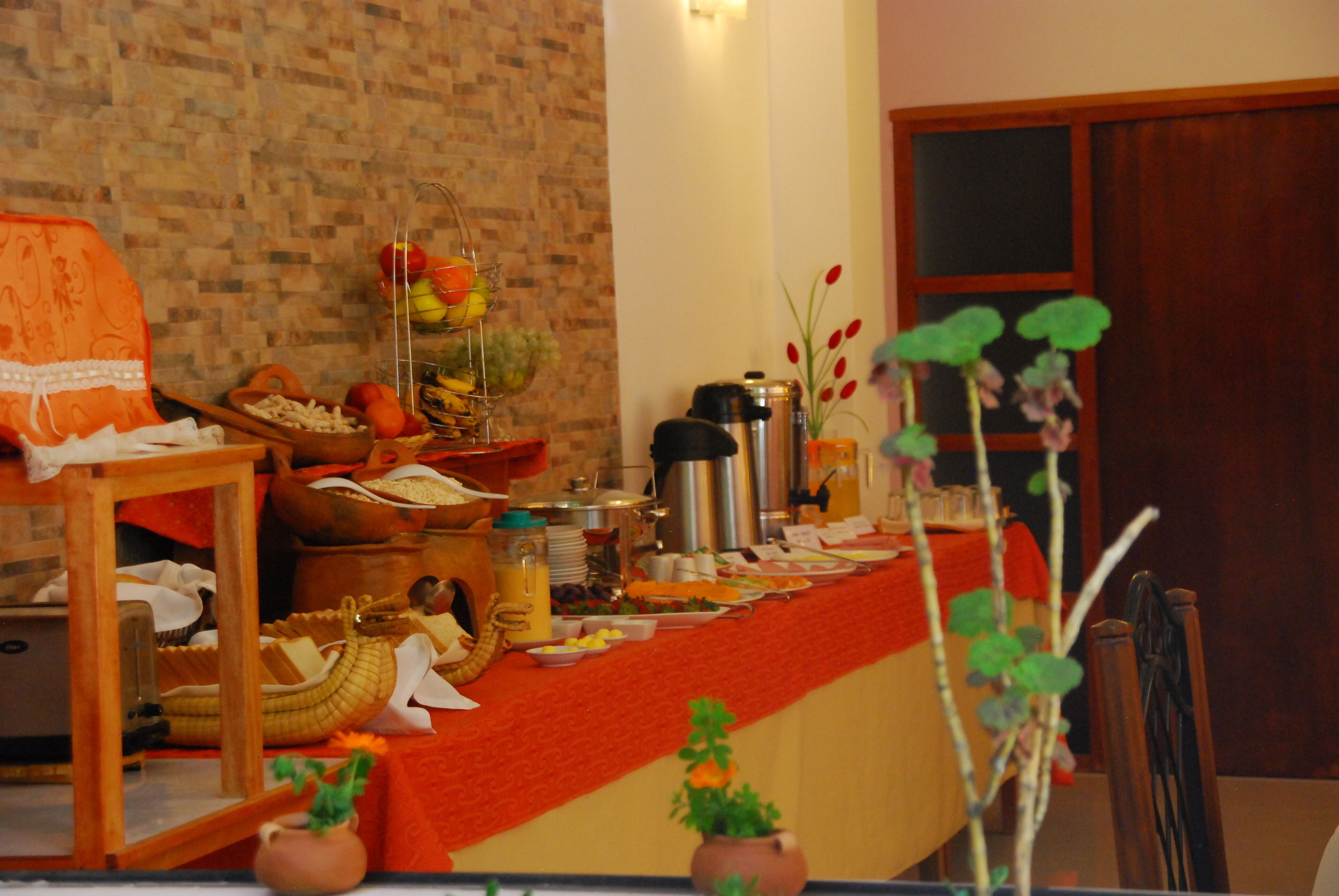 A buffet table with various food items and a coffee maker.