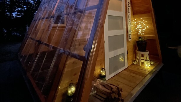 A small, wooden cabin with a slanted roof and large windows. - Lakefront Transforming Micro Cottage on Cherokee Lake  (Mooresburg)