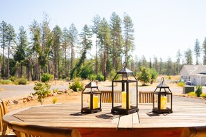 A wooden deck with three lanterns and a bench. - Quiet Paradise Family Home With A View  (Paradise)