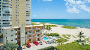 A hotel with a pool, beach view, and multiple balconies. - DIRECTLY ON BEACH! JUST STEPS TO THE OCEAN Free Parking Full Kitchen Heated Pool (Pompano Beach)