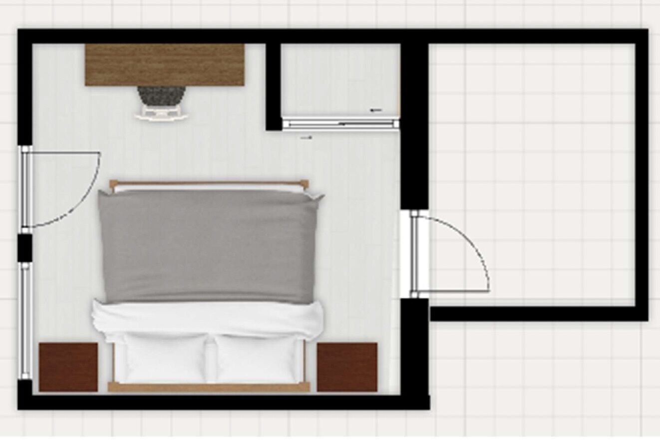 A bedroom with a bed, a bedside table, a nightstand, and a window.