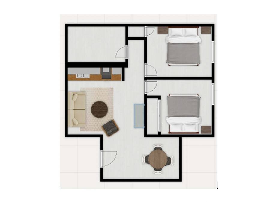 A floor plan of a hotel room with a bed, a seating area with a table, and a small kitchenette.