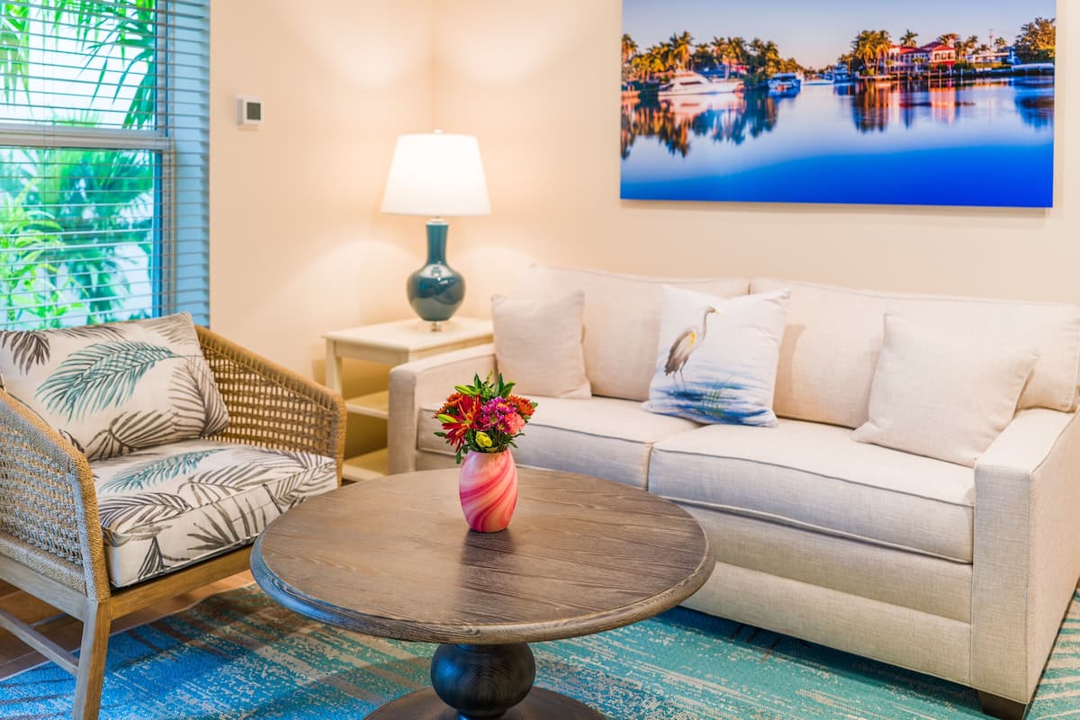 Room 504 - One bedroom suite | Living room | 65-inch flat-screen TV with digital channels