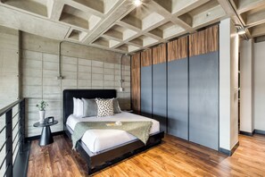 A modern bedroom with a large bed, a small bedside table, and a wardrobe. - Downtown Loft by ULIV (Tijuana)