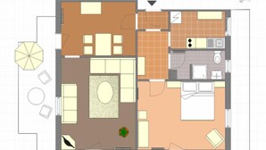 A floor plan of a hotel room with a living area, kitchen, bathroom, and a balcony.