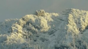 A snow-covered mountain with rugged terrain and no visible structures or people.