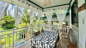 A room with a bed, a chair, and a view of greenery outside. - Punta Isla Lake Resort (Lake Sebu)