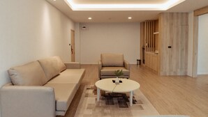 A modern living room with a sofa, armchair, and coffee table. - RUS Hotel&Convention (Ayutthaya)
