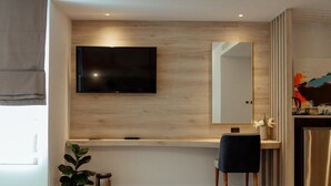 A modern kitchen with a built-in TV, a wooden countertop, and a stainless steel refrigerator. - RUS Hotel&Convention (Ayutthaya)