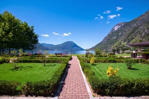 A pathway leading to a lake with mountains in the background.