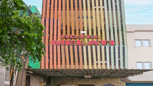 A hotel named "HOTEL MELATI" with a modern facade featuring vertical wooden slats. - Hotel O Melati (South Tangerang)