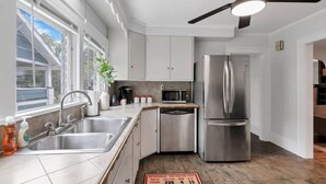 A modern kitchen with stainless steel appliances, a dishwasher, and a sink. - The Ohio State of Mind - OSU-Themed 5BR Home in Clintonville (Columbus)