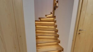 A wooden staircase with a handrail, leading to an upper floor. - U Krále by Interhome (Kořenov)