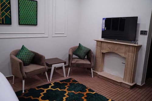 Deluxe Room | Living area | 45-inch LED TV with cable channels