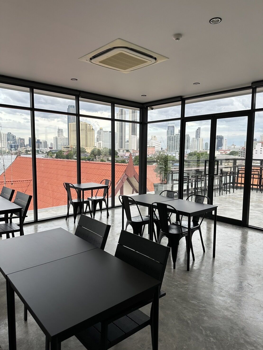 A modern dining area with large windows offering a city view.