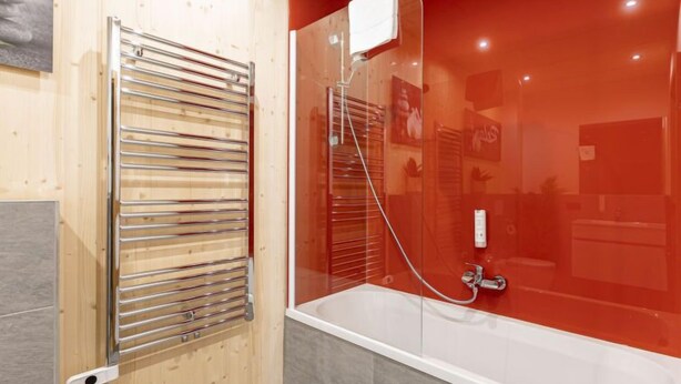 A modern bathroom with a glass shower enclosure, a built-in towel rack, and a visible control panel. - #2a mit Sauna & Pool by Interhome (Sankt Georgen am Kreischberg)