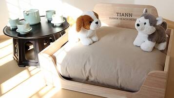 Relax in a serene space with a plush sofa, light-colored seating, and a minimalist design.