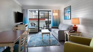 A hotel room with a dining area, a sofa, a TV, and a balcony with outdoor seating. - Beach Bash: Partial OV King Suite 6th Floor (Myrtle Beach)