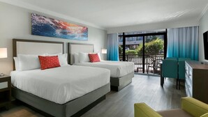 A hotel room with two beds, a balcony with a view, and a desk with chairs. - Sandy Toes Resort View Room 1st Floor (Myrtle Beach)