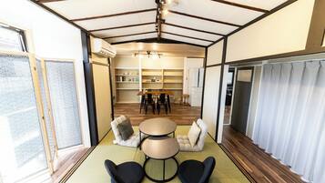 A compact living space with a dining area, a sofa, and a small table.