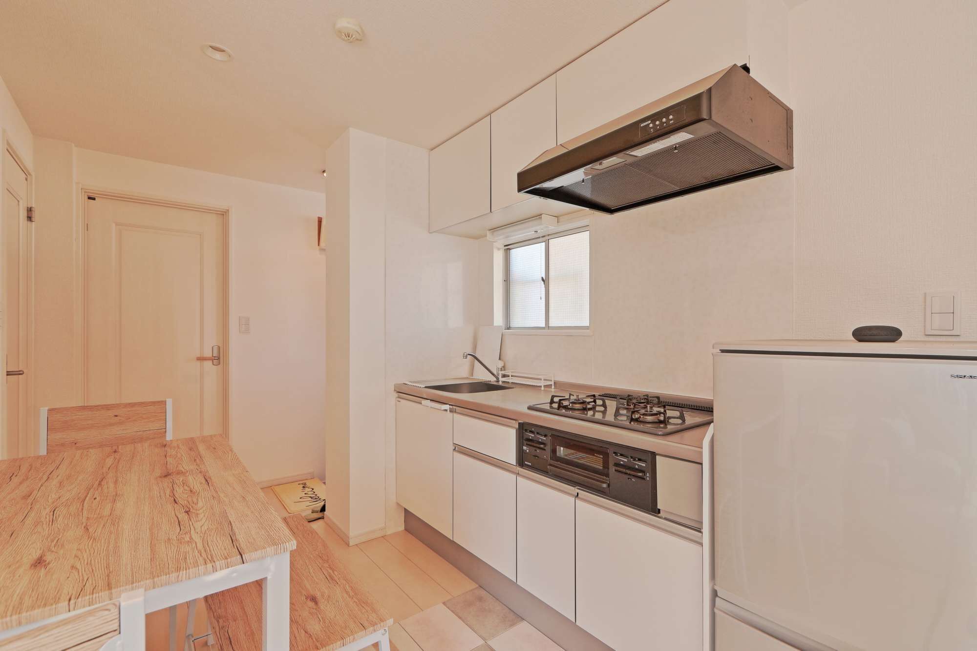 A compact kitchen with a gas stove, oven, and dishwasher.