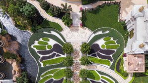 An aerial view of a landscaped area with a central fountain, surrounded by manicured gardens and pathways. - Andaz Macau  (Cotai)