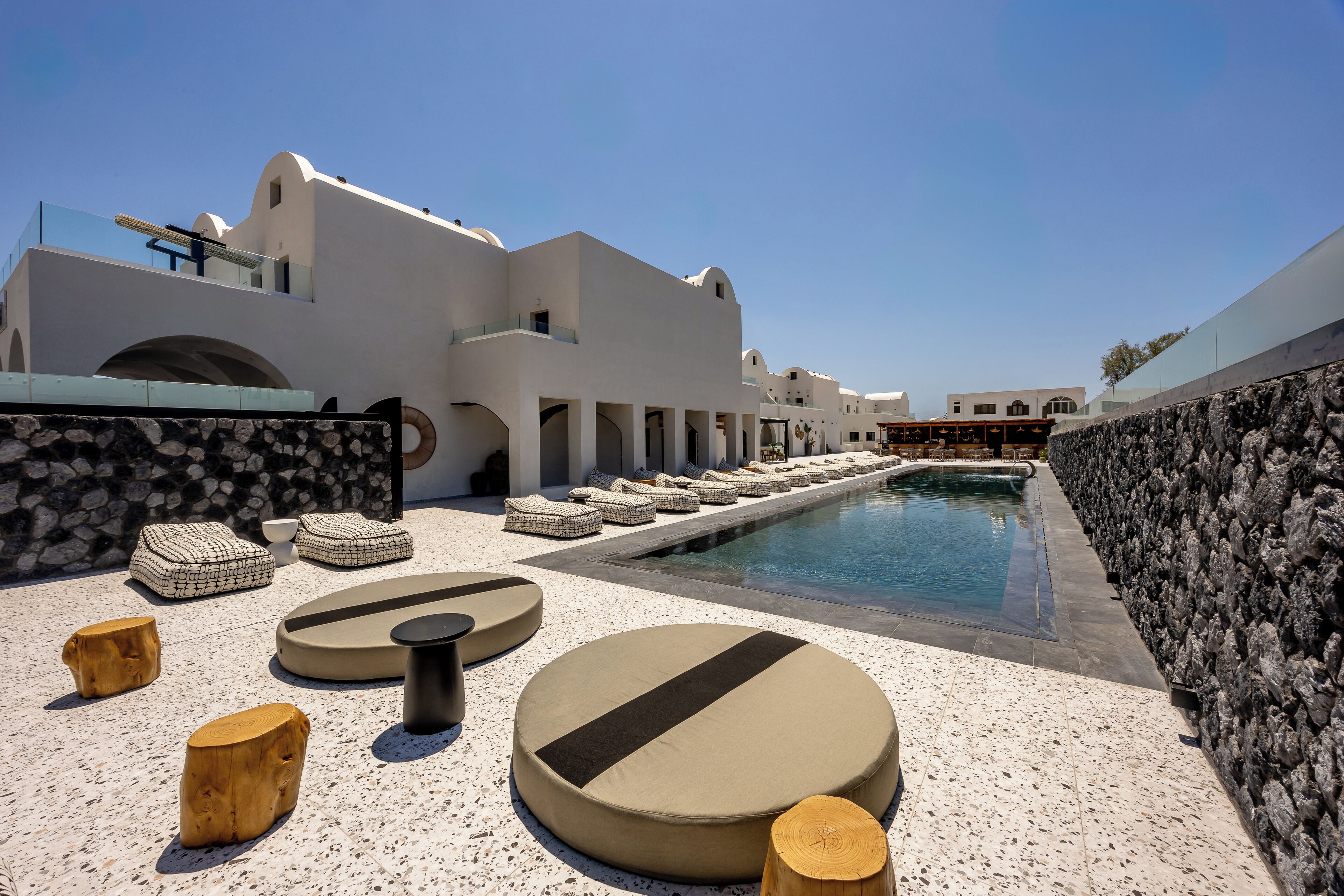 A poolside area with lounge seating and a clear view of the pool.