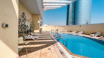 Outdoor pool, pool loungers, lifeguards on site