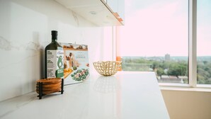 Una encimera de cocina con una botella, un libro de recetas y una cesta de mimbre.