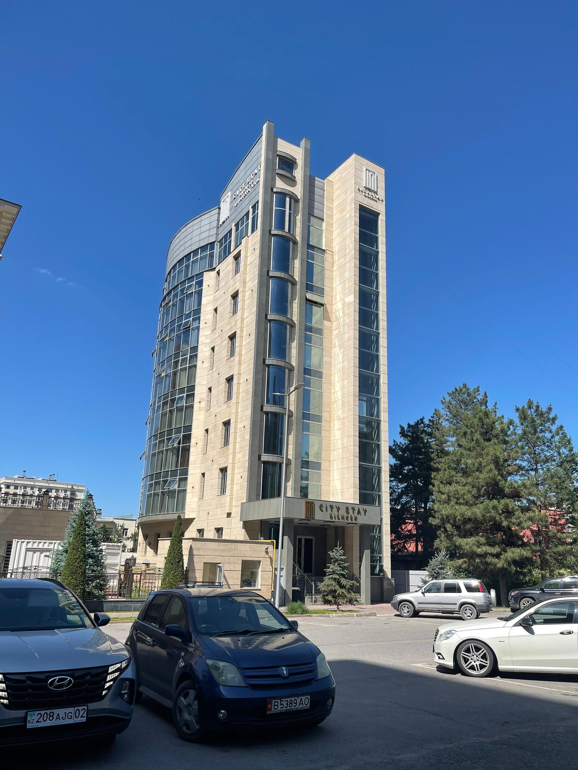 A multi-story hotel with a modern design, featuring large windows and a prominent entrance.