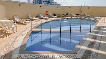 Outdoor pool, pool loungers, lifeguards on site