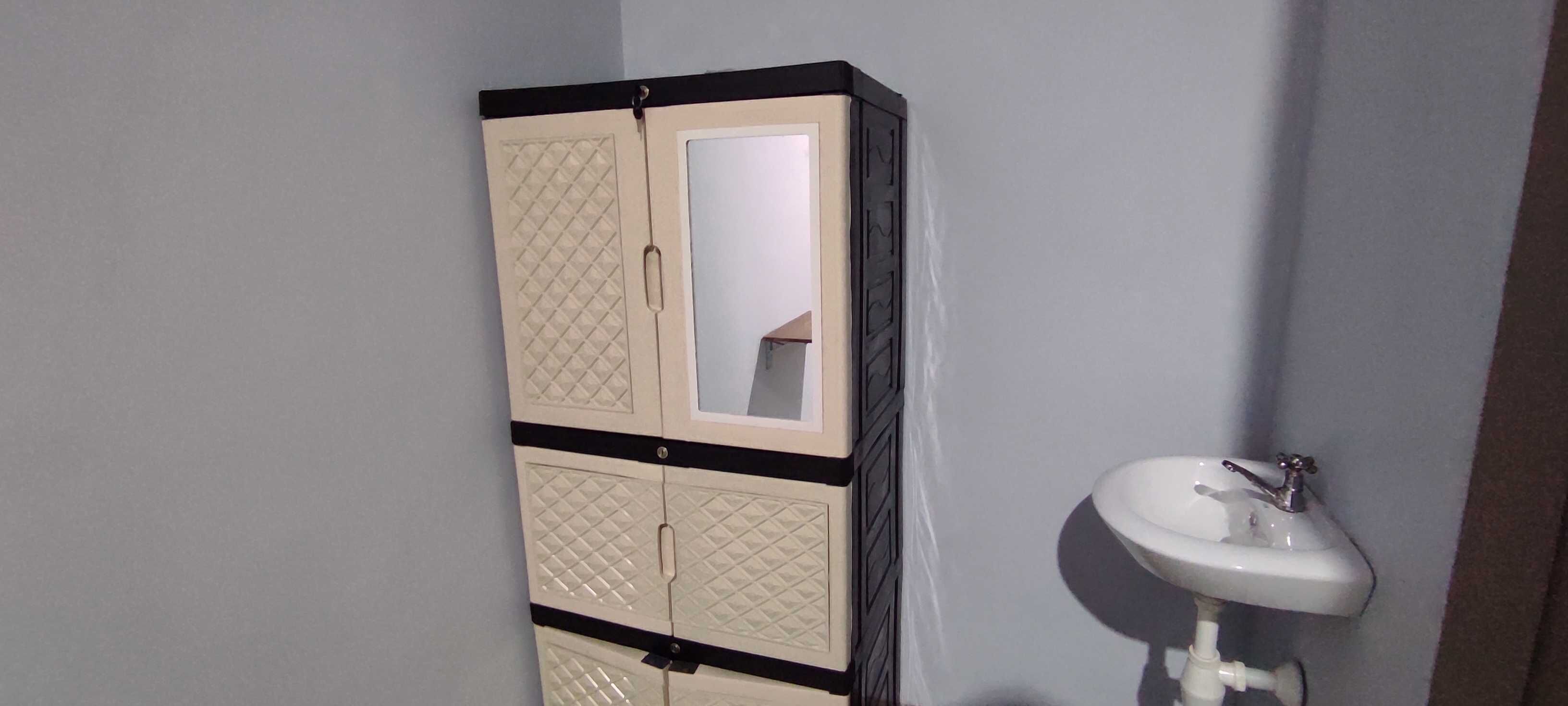 A bathroom with a cabinet and a sink.