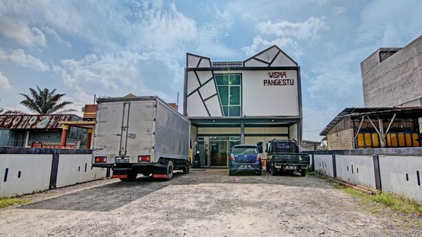 A building with a sign reading "WISMA PANGESTU" and a truck parked in front. - Hotel O Wisma Pangestu SyariahNearTamanselera (Ujungtanjung)