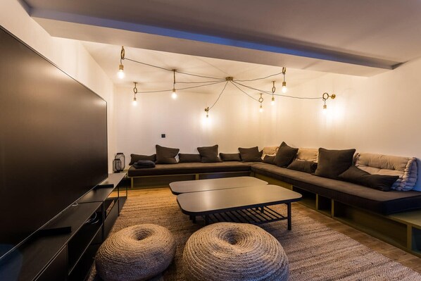 A modern living room with a sectional sofa, a flat-screen TV, and a coffee table. - KABANE. KEYWEEK. Villa pool spa sauna downtown (Biarritz)