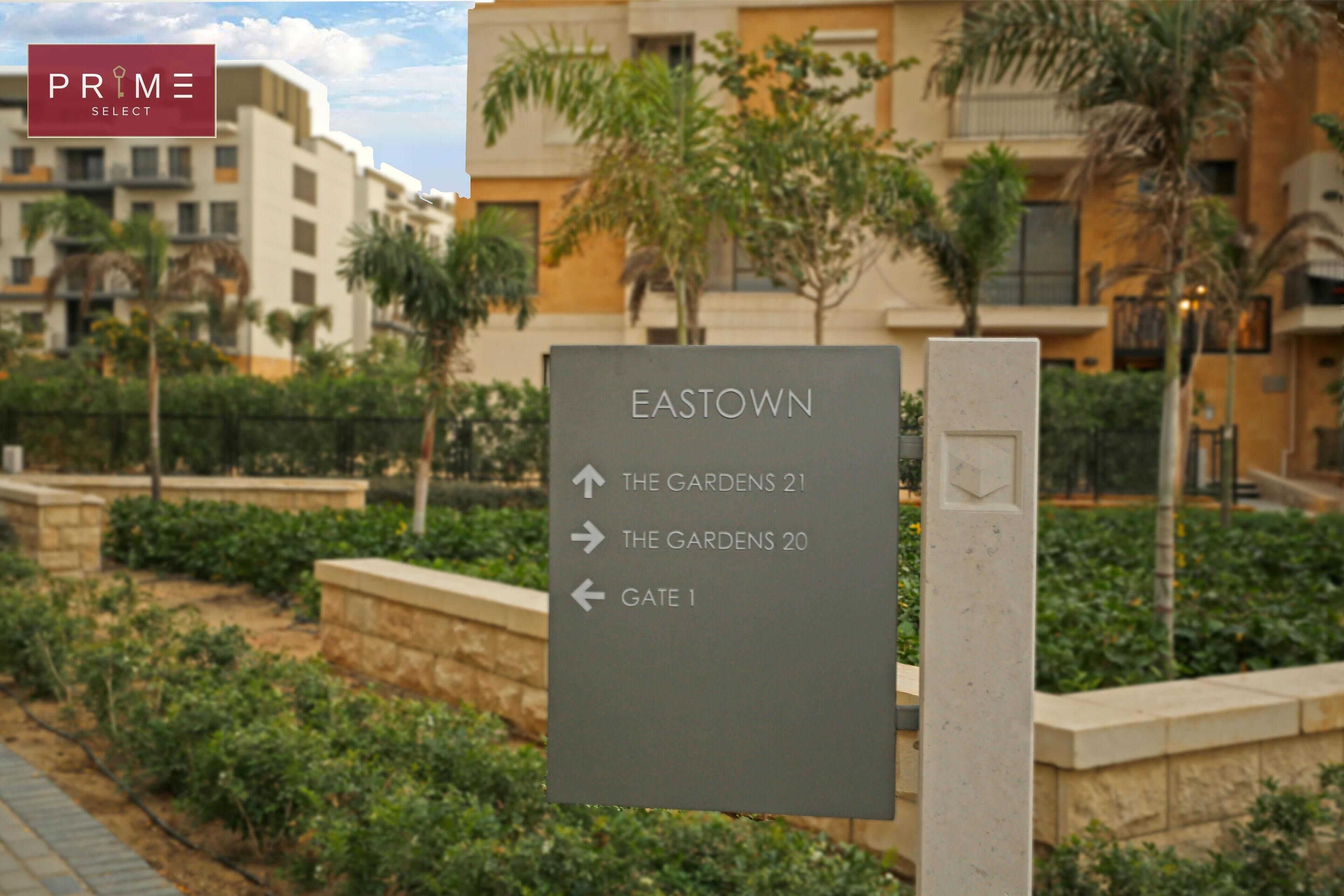 A directional sign for EASTOWN with arrows pointing to THE GARDENS 21, THE GARDENS 20, and GATE 1.
