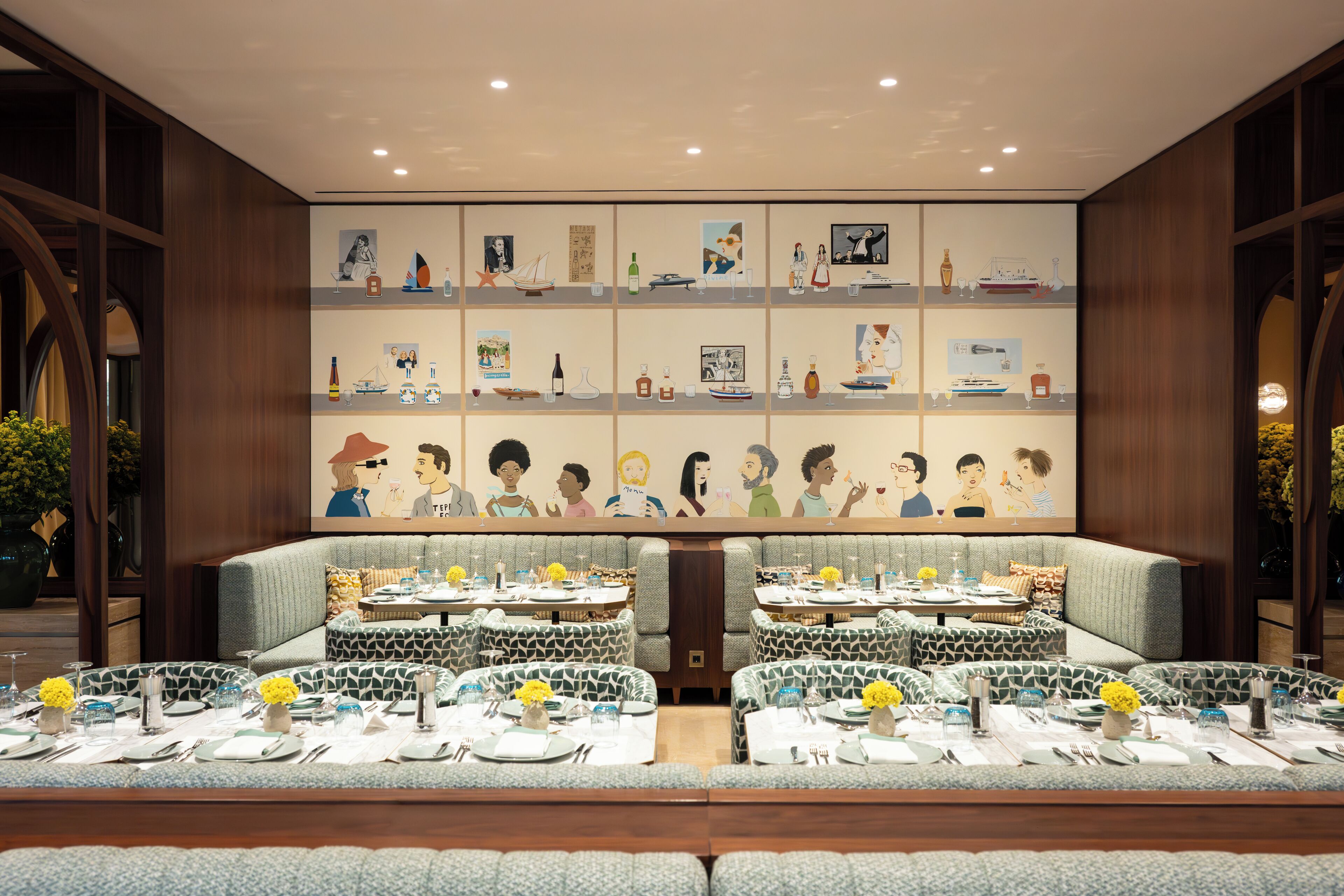 A restaurant with a long table and booths, featuring artwork on the walls and a modern interior design.